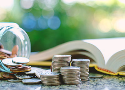 Coins from jar near book