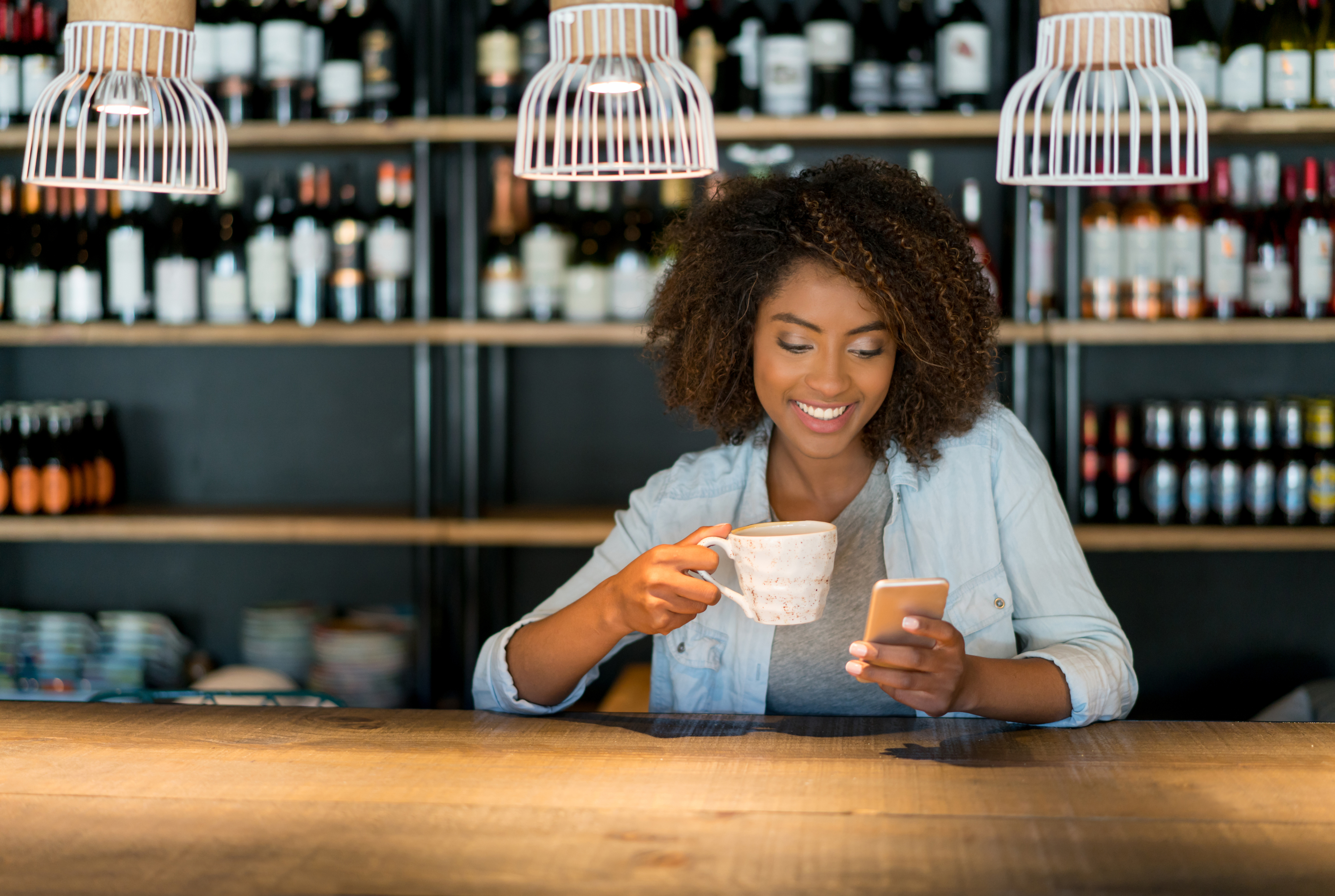 Woman with cup and phone