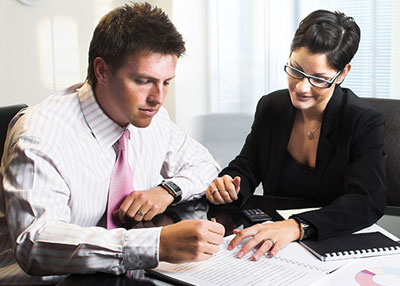 Man and woman checking reports
