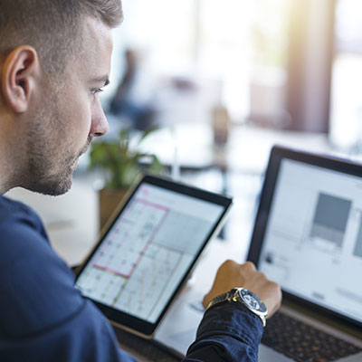 Person with laptop and tablet