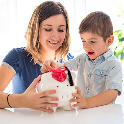 Mom and son with piggy bank