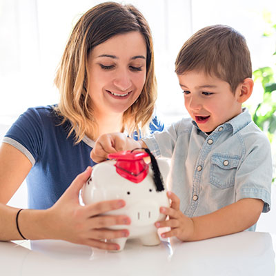 Mom and son with a piggy bank