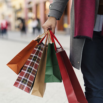 a hand holding shopping bags